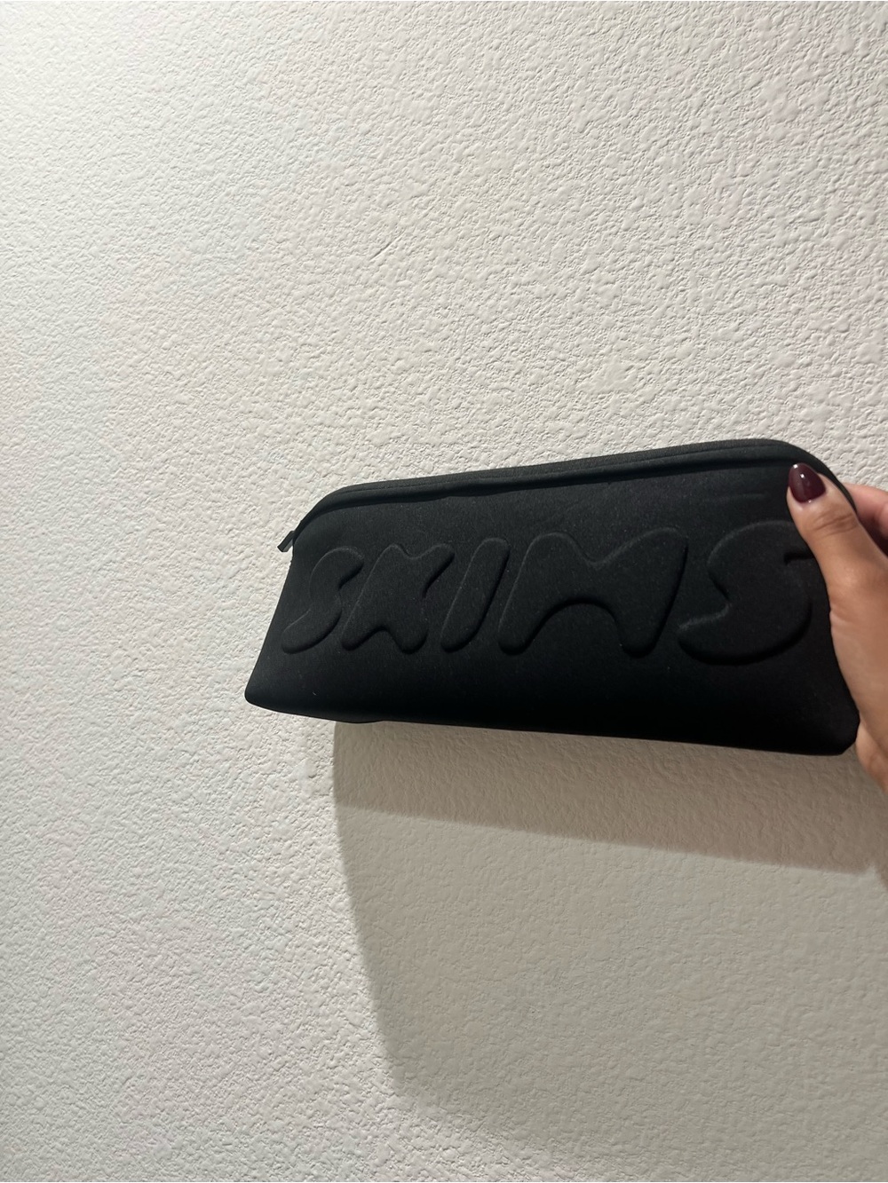 SKIMS Black Embossed Logo Zip Pouch